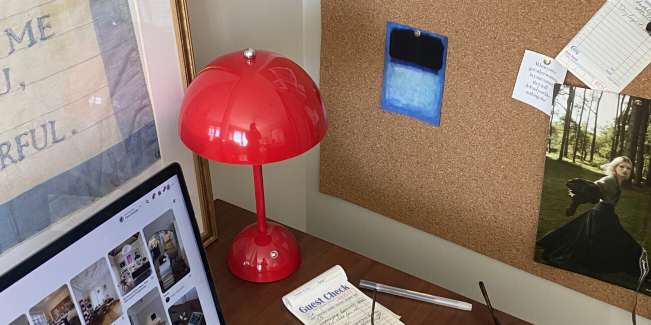 Computer on desk with a red lamp