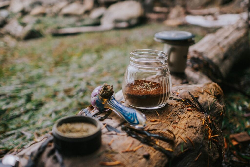 Smoke pipe on a log with a jar