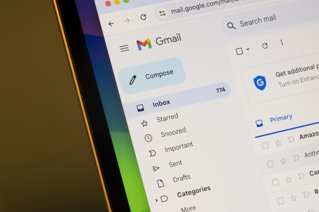 A laptop showing a glimpse of someones gmail inbox
